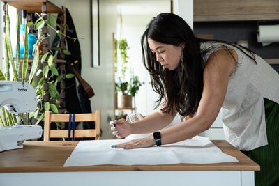 Verge reporter, Mia Sato works on a dress she is making from a vintage pattern at her makeshift sewing station - her dining room table - at her home in Brooklyn, NY. on June 9th, 2022